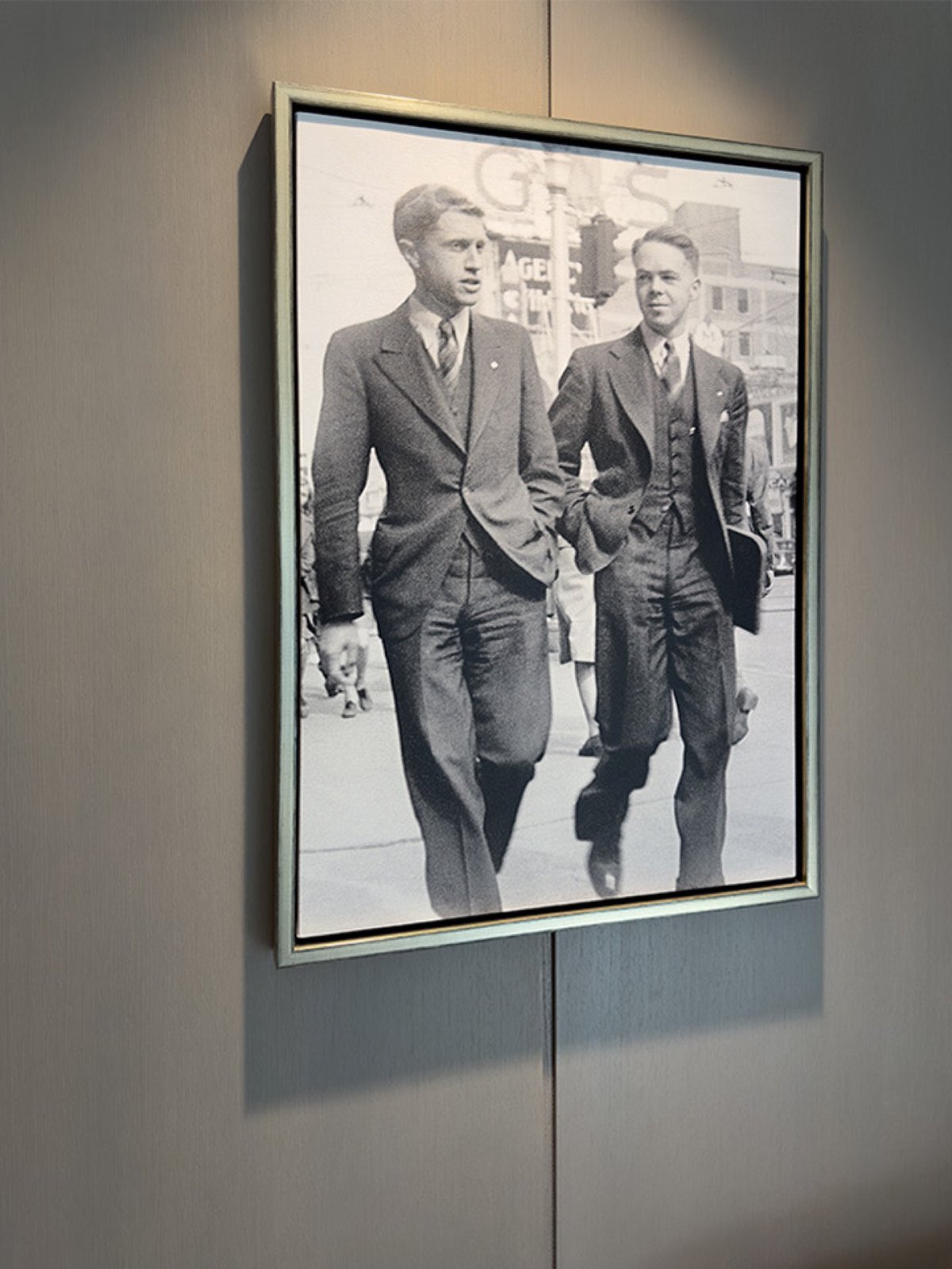 A black and white photo of Bishop & McKenzie founders, Ted  Bishop and Ken McKenzie walking along Jasper Avenue, 1950.